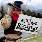 Rooster mascot holding a Rooster's Rally banner